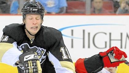 Jordan Staal fights Carolina's Tuomo Ruutu for the puck late in last night's game at Mellon Arena.
