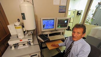 A.J. "Skip" Schwoeble, director of forensic science at RJ Lee Group Inc., sits with a scanning electron microscope linked to a computer at the company's headquarters in Monroeville.