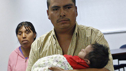 Rosa Sirilo-Francisco, left, and Andres Cruz yesterday as they are leaving the Plant City, Fla. police center with their 2-month-old daughter, Sandra Cruz-Francisco.