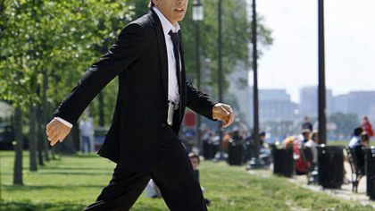 Actor Ben Stiller strides across the National Mall while filming a scene for the movie, "Night at the Museum: Battle of the Smithsonian," in Washington.