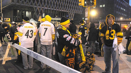 Steelers fans wait in the early morning hours for the prime spots near the grandstand at the Boulevard of the Allies at Stanwix Street.