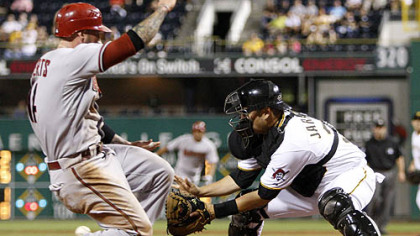 Pirates catcher Jason Jaramillo  waits for the throw from left field as Diamondbacks infielder Ryan Roberts slides in the eighth inning.