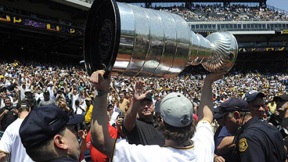 The PNC Park crowd erupts as Sidney Crosby hoists the Stanley Cup before the game against the Tigers yesterday, Many members of the NHL champion Penguins attended the game.