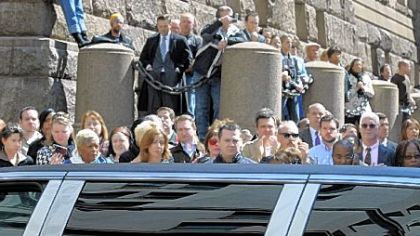 A crowd along Grant Street, Downtown, watches as the memorial procession passes by.
