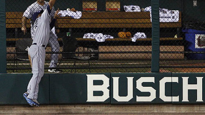 Rays outfielder Carl Crawford makes a catch on a ball hit by Rockies outfielder Brad Hawpe during seventh inning.
