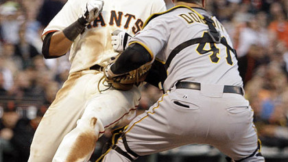 Giants first baseman Jesus Guzman is forced out at home plate by Pirates catcher Ryan Doumit during the second inning.