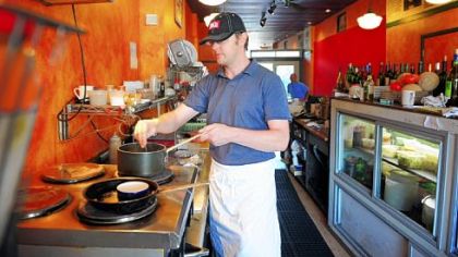Owner Paul Krawiec works in the tight quarters of the kitchen at Cafe du Jour.