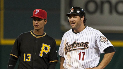 Astros first baseman Lance Berkman jokes with Pirates shortstop Ronny Cedeno after hitting a double during the third inning.