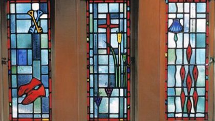 Windows created by Henry Hunt Studios  for a chapel in the bishop's mansion. The symbols in the windows describe the duties of a bishop, and were commissioned by Bishop John Dearden.