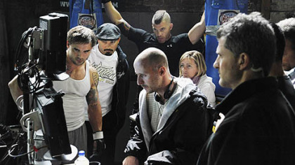 Cast and crew gather around director Gavin O'Connor to watch a take during the filming of "Warrior" in the Gage Building in the Strip District on Tuesday.