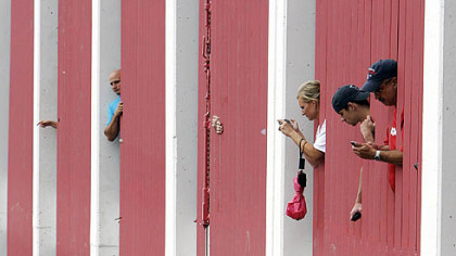 Spectators watch from a parking garage as All-Star players are driven to Busch Stadium before the game.
