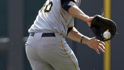 Pirates first baseman Garrett Jones fields a ground ball hit by Reds first baseman Joey Votto for an out in the fourth inning.