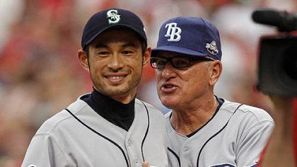 Rays manager Joe Maddon chats with Mariners outfielder Ichiro Suzuki before the game.