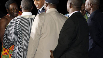 President Barack Obama, third from left, is greeted in Accra, Ghana, after his arrival this evening.