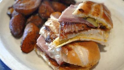 A pressed Cuban sandwich, backstopped with fried plaintains at the Starliner Diner in Hilliard, Ohio. The bread is baked daily and the pressed sandwich offers the traditional fillings of ham, roast pork, Swiss cheese, mustard and pickle.