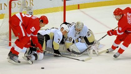 Detroit's Jonathan Ericsson, left, battles in front of the Penguins' net Saturday -- three days after having an appendectomy.