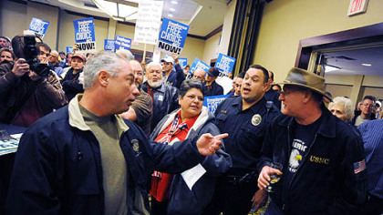 Regal Mobrey, left, of McKees Rocks, a supporter of the Employee Free Choice Act, and Dennis Badstibner, far right, of Ross, an opponent, face off at the Radisson Hotel in Green Tree yesterday.
