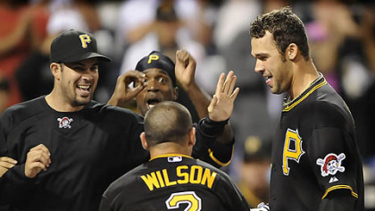 The Pirates mob outfielder Garrett Jones at home after his walk-off home run in the 14th inning.