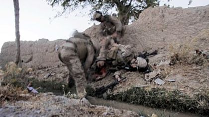 Fellow Marines tend to Lance Cpl. Joshua Bernard after he was hit by a rocket-propelled grenade in Afghanistan.  Lance Cpl. Bernard later died of his wounds,
