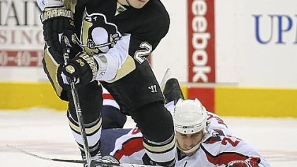 Penguins left winger Ruslan Fedotenko skates past the Washington Capitals' Milan Jurcina in Game 3 at Mellon Arena.