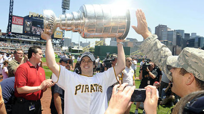 Sidney Crosby hoists the Stanley Cup at PNC Park yesterday.