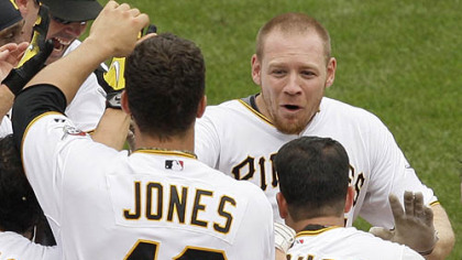 Pirates outfielder Brandon Moss, top right, is greeted by teammates as he arrives home after hitting a game-winning walk-off solo home run off Brewers pitcher Mitch Stetter in the ninth inning.