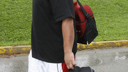 Steelers offensive lineman Chris Kemoeatu carries his bags to the dorms as he arrives at training camp.