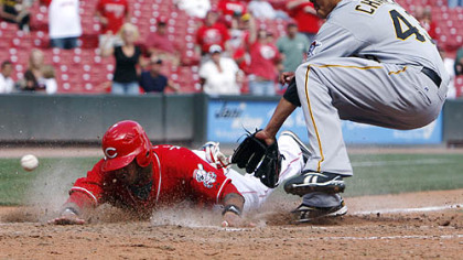 Reds outfielder Darnell McDonald slides across home plate with the winning run after a wild pitch from Pirates pitcher Jesse Chavez in the bottom of ninth inning of the first game.