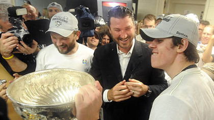 Dripping with champagne, from left, Sergei Gonchar, Mario Lemieux and Evgeni Malkin celebrate with the Stanley Cup after defeating the Red Wings in seven games Friday. Normally hands off, Lemieux provided the Penguins players and coaches with uplifting support throughout the long two months of the Stanley Cup playoffs.