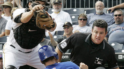 Pirates catcher Jason Jaramillo can''t handle the throw from center fielder Andrew McCutchen as Cubs outfielder Kosuke Fukudome scores from third on a sacrifice fly by Cubs third baseman Jeff Baker during the first inning.