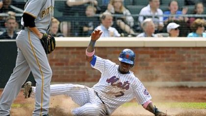 Pirates reliever John Garbow, left, returns to the mound as Mets' Jose Reyes, right, scores on teammate Carlos Beltran's eighth-inning, two-run double to deep left field.