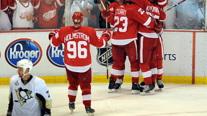 Red Wings players converge on Valtteri Filppula to celebrate his go-ahead goal in the second period last night.