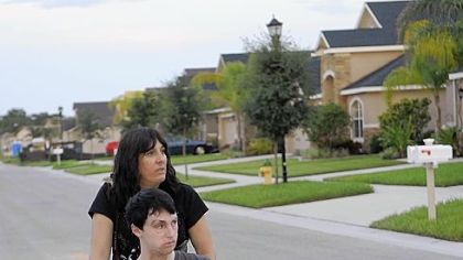 After a long day, Leslie walks with Kevin through their new neighborhood in Riverview, Fla.