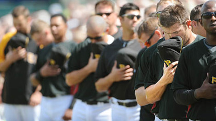 Second baseman Freddy Sanchez (second from right) hangs his head during the national anthem Feb. 25 in Bradenton, Fla. The Pirates believe there is a buzz in the locker room and Sanchez says he's having the most fun he's ever had in spring training.