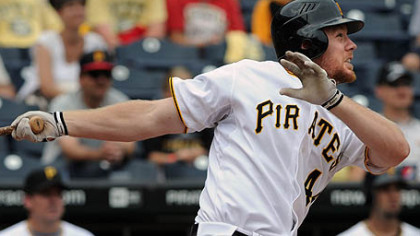 Pirates outfielder Brandon Moss watches as his game-winning homer in the ninth inning against the Brewers sails over the center field wall at PNC Park yesterday.