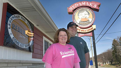 Heidi and Charlie Maroney stand outside Redamak's, a popular restaurant in New Buffalo, Mich. , where they both work. His grandparents, Jim and Angie Maroney, bought the business in 1975.