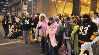 Steelers fans gather next to the grandstand, waiting for the noon parade.