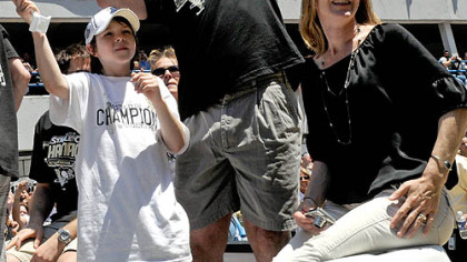 Penguins head coach Dan Bylsma, with his son, Bryan, and wife, Mary Beth, waves to the crowd along the Boulevard of the Allies yesterday afternoon.