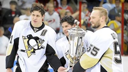 From left, Evgeni Malkin, Sidney Crosby and Sergei Gonchar pose with the Prince of Wales Trophy after beating the Carolina Hurricanes to win the Eastern Conference title last night.