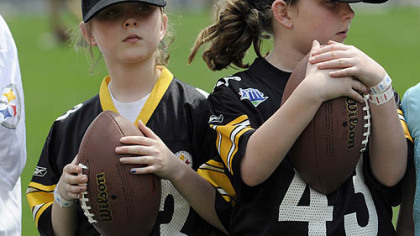 Abigail and Emily Lovell, 10, wait for a lesson from Pittsburgh Steelers quarterback Charlie Batch during the Steelers 2009