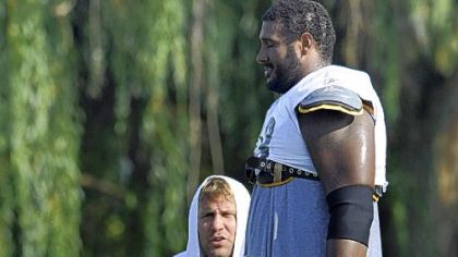 Ben Roethlisberger talks with Max Starks near the end of practice yesterday. Roethlisberger injured his right foot when Starks fell on him during pass drills near the end of practice.