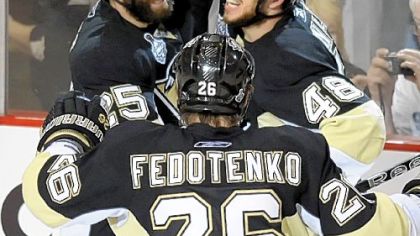 The Penguins' Tyler Kennedy, right, is congratulated by teammates Max Talbot and Ruslan Fedotenko after his third-period goal in Pittsburgh's 2-1 win over the Detroit Red Wings in Game 6 of the Stanley Cup final last night at Mellon Arena.