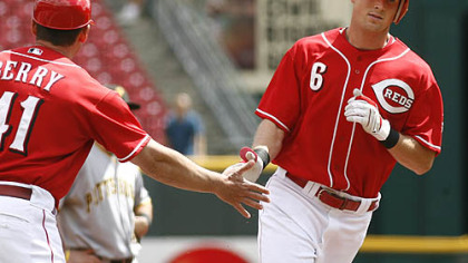 Reds outfielder Drew Stubbs is congratulated by third base coach Mark Berry after Stubbs hit a solo home run off  Pirates pitcher Daniel McCutchen in the first inning of the first game.