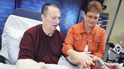 Jeff Kepner, the nation's first bilateral hand transplant recipient, and his wife, Valarie, hold hands shortly after a news conference yesterday at Montefiore Hospital.