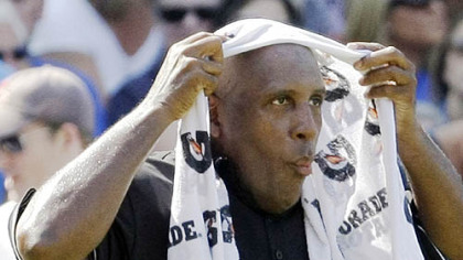 Home plate umpire Chuck Meriwether cools off with a wet towel in between innings Friday.