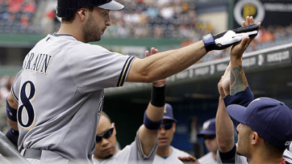 Brewers outfielder Ryan Braun is greeted by teammates in the dugout after hitting a first-inning solo home run off  Pirates pitcher Paul Maholm.