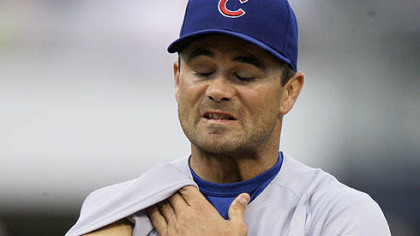 Cubs pitcher Ted Lilly uses his sleeve to wipe his face on the mound during the third inning of last night's game.