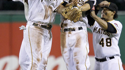 Pirates Andrew McCutchen, Jack Wilson, Freddy Sanchez and Delwyn Young, from left, celebrate after the final out of their 3-0 home win against the Cubs last night.