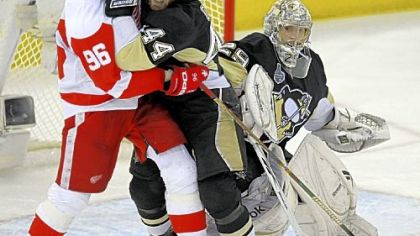 Brooks Orpik battles Detroit's Tomas Holmstrom in front of Marc-Andre Fleury. Fleury registered 25 saves in helping send the series back to Detroit for Game 7 Friday night at Joe Louis Arena.