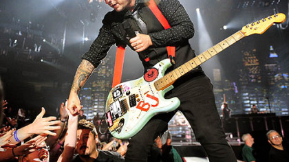 Green Day's Billie Joe Armstrong greets the fans at Mellon Arena last night.